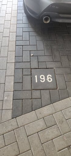 A picture of a parking space numbered '196'